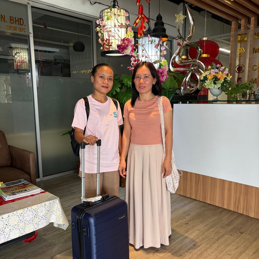 A new helper arriving at the Smart Recruit office with her employer